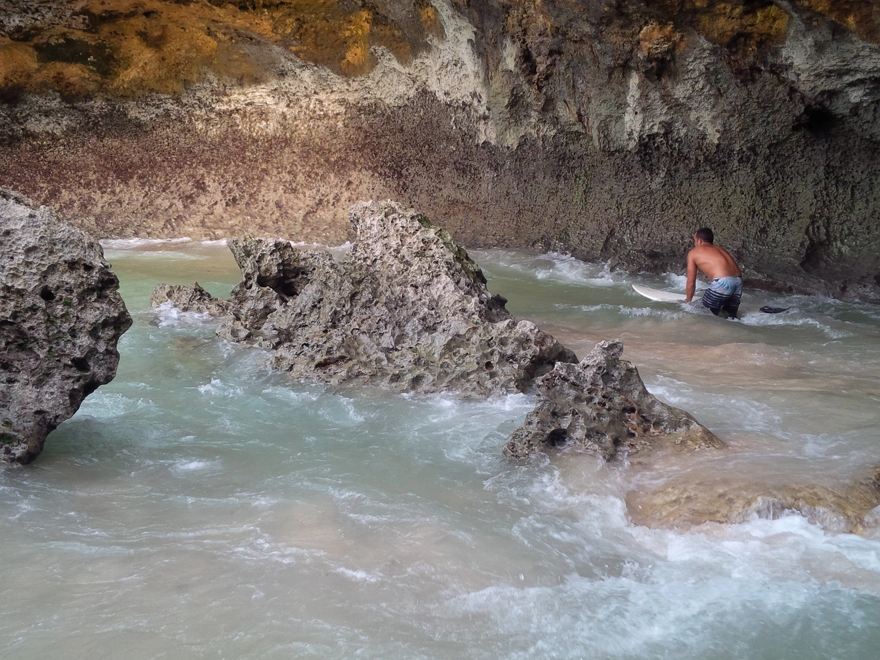 Surfers and coastal scenery at Blue Point Beach Uluwatu